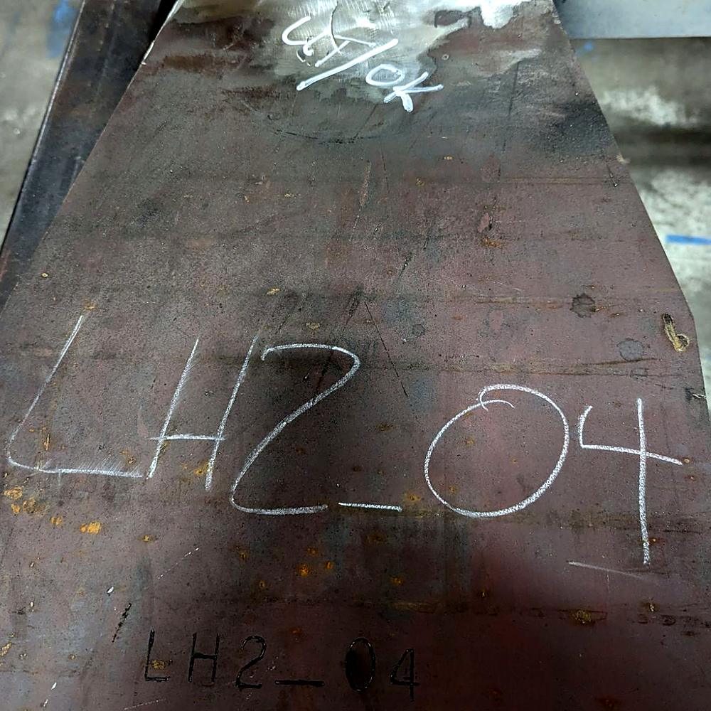Part LH2_04, its number etched in and chalked on, its weld marked UT OK